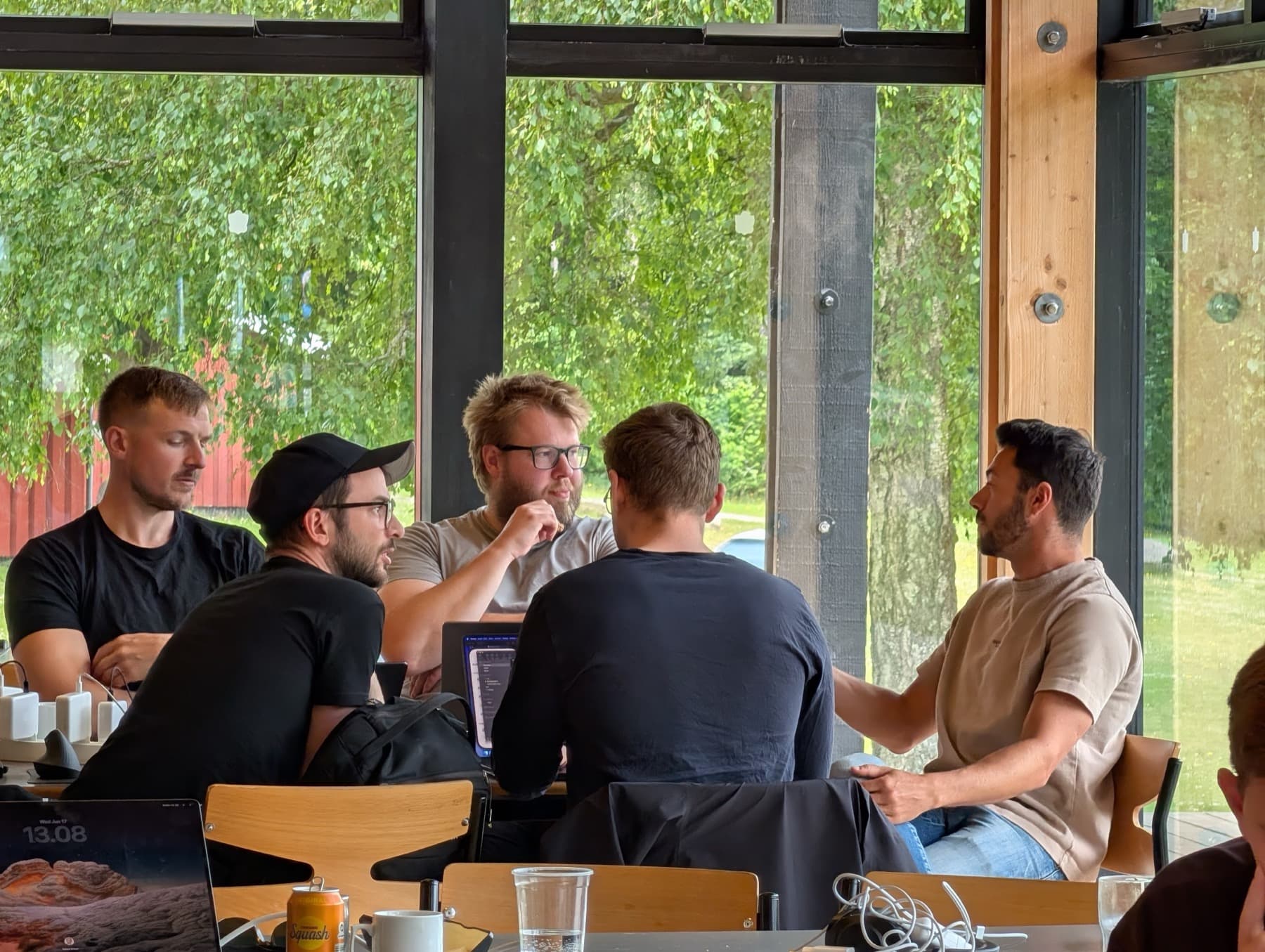 A small team discussing an idea by the window